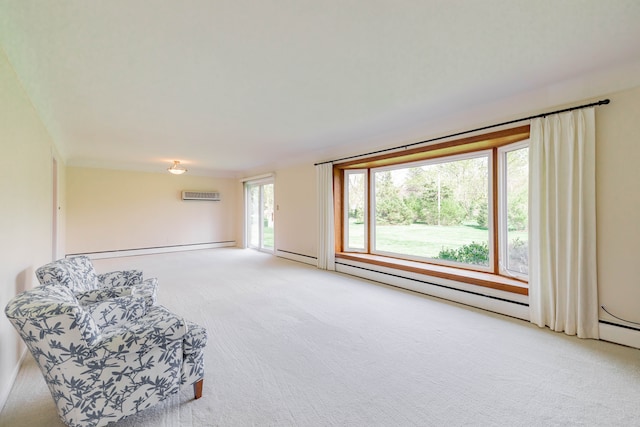 unfurnished room featuring a baseboard radiator, a wall mounted air conditioner, and light carpet