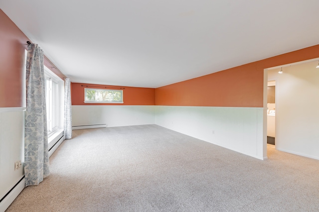 unfurnished room featuring a baseboard heating unit, carpet, and a baseboard radiator
