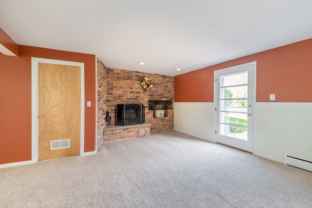 unfurnished living room with carpet floors, visible vents, baseboard heating, and a fireplace