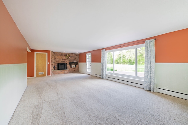 unfurnished living room with carpet floors, visible vents, wainscoting, and a fireplace