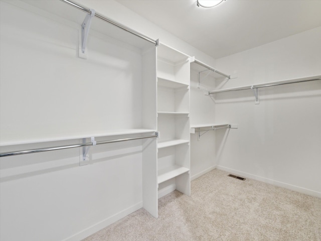 spacious closet with visible vents and light carpet