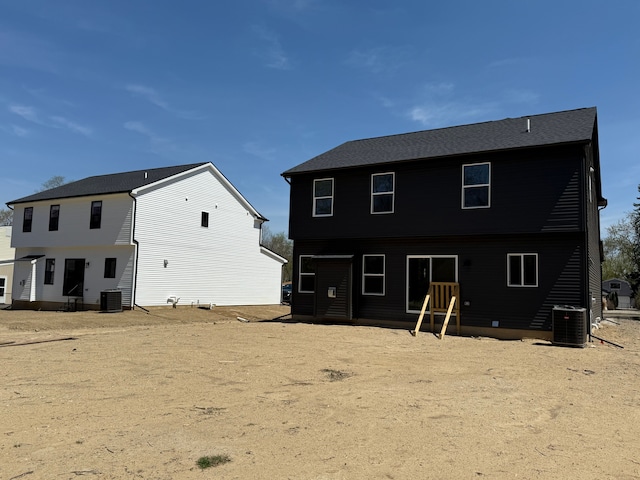 back of house with central air condition unit