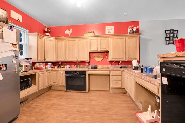 kitchen featuring light brown cabinetry, black appliances, and light countertops