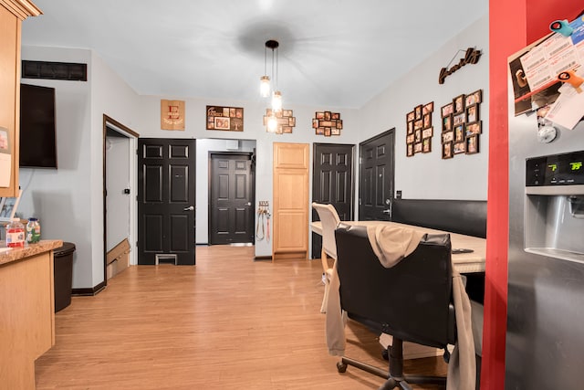 home office with visible vents and light wood-style flooring