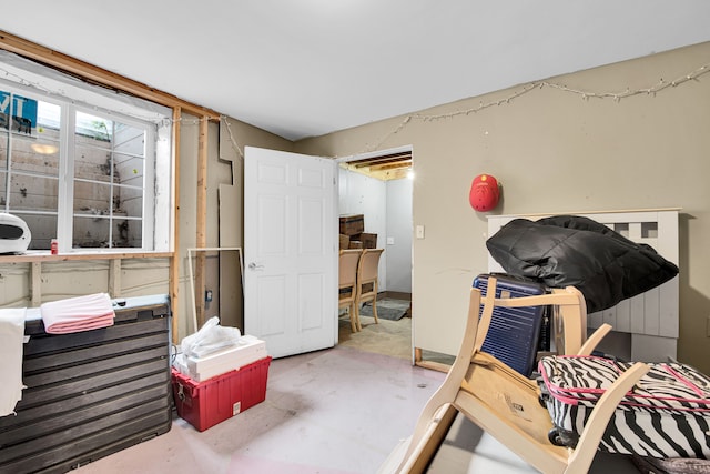 bedroom featuring concrete flooring
