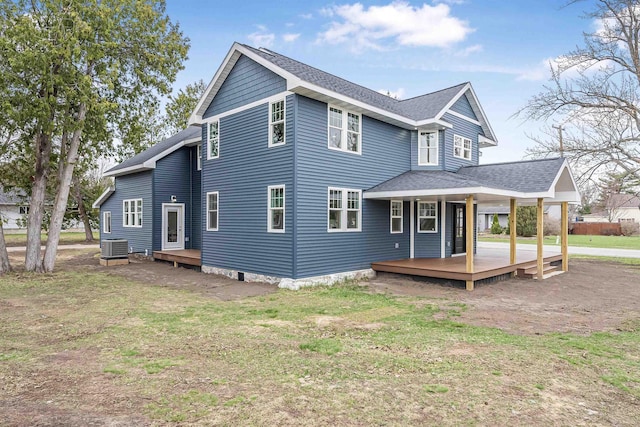 rear view of house featuring a wooden deck, a yard, a shingled roof, and central air condition unit