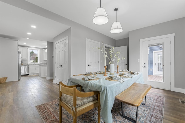 dining room featuring dark wood finished floors, visible vents, recessed lighting, and baseboards