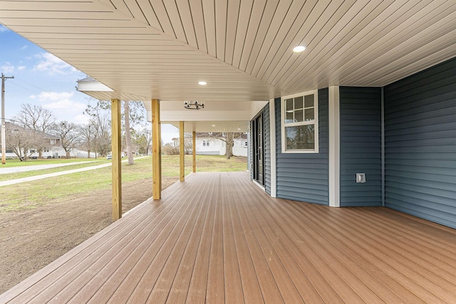 deck with a porch and a lawn