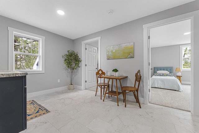dining space featuring recessed lighting, marble finish floor, and baseboards