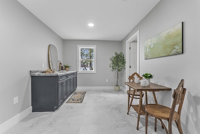 bar with marble finish floor and baseboards