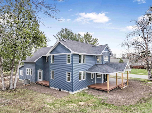 back of house featuring a wooden deck, central AC, and a shingled roof