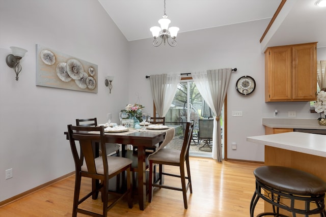 dining space with vaulted ceiling, a chandelier, light wood-style floors, and baseboards