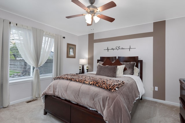 bedroom with light carpet, baseboards, and a ceiling fan