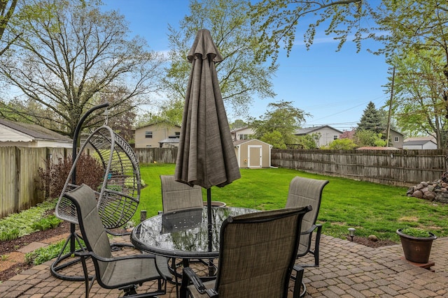 view of patio with outdoor dining space, a storage shed, and an outdoor structure