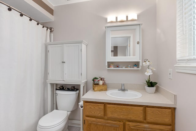 full bathroom with toilet and vanity