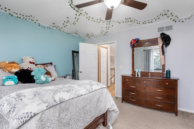 bedroom with light colored carpet, a ceiling fan, and baseboards