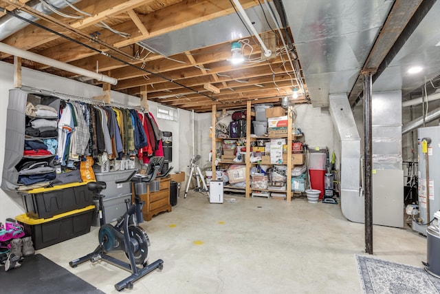 unfinished below grade area featuring water heater and heating unit