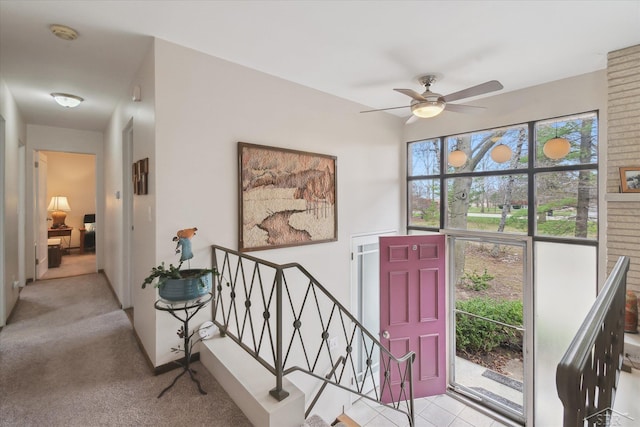 carpeted foyer featuring a ceiling fan