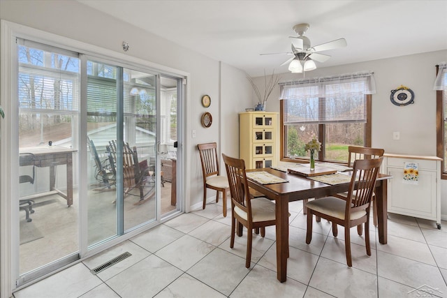 dining space featuring visible vents, light tile patterned floors, a wealth of natural light, and ceiling fan