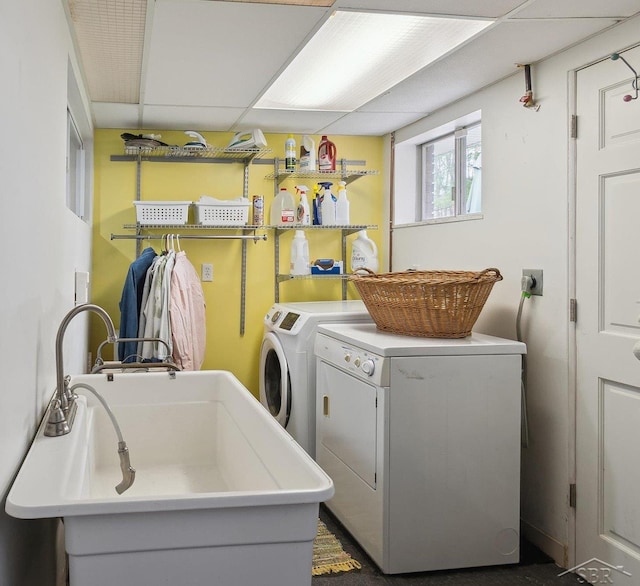 laundry area with separate washer and dryer, a sink, and laundry area