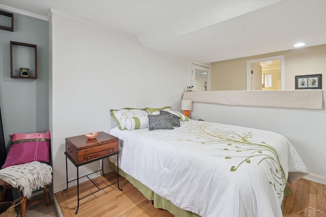 bedroom with ornamental molding, recessed lighting, and wood finished floors