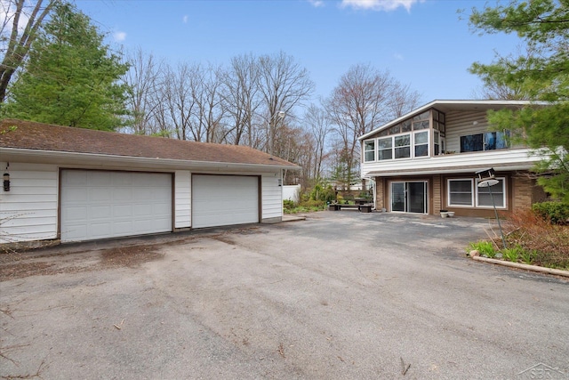 exterior space with a detached garage and an outdoor structure