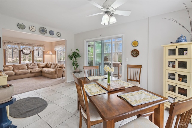 dining space featuring light tile patterned floors, ceiling fan, and baseboards