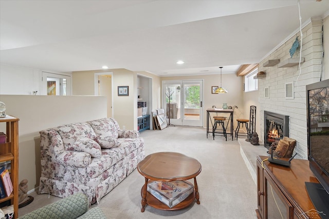 living area with recessed lighting, light colored carpet, and a brick fireplace