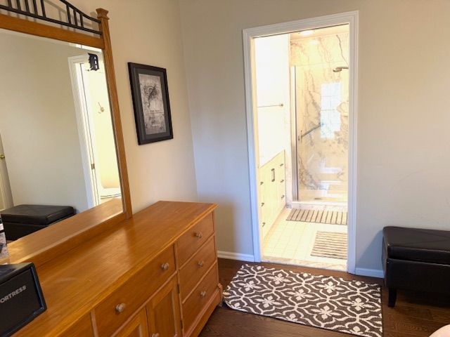 doorway to outside with baseboards and dark wood-style flooring