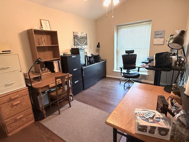 office area with a ceiling fan, wood finished floors, lofted ceiling, and baseboards