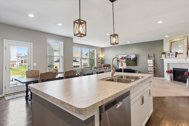 kitchen with a sink, dishwasher, recessed lighting, open floor plan, and dark wood-type flooring