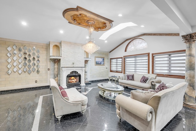 living area with recessed lighting, granite finish floor, a fireplace, baseboards, and lofted ceiling with skylight