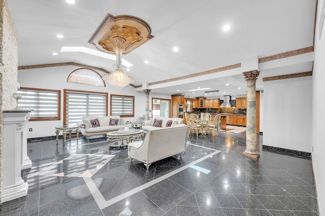 living room with baseboards, decorative columns, granite finish floor, and recessed lighting