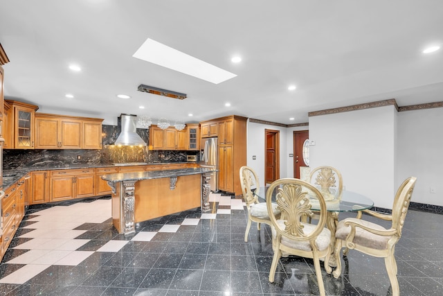dining space with recessed lighting, a skylight, granite finish floor, ornamental molding, and baseboards