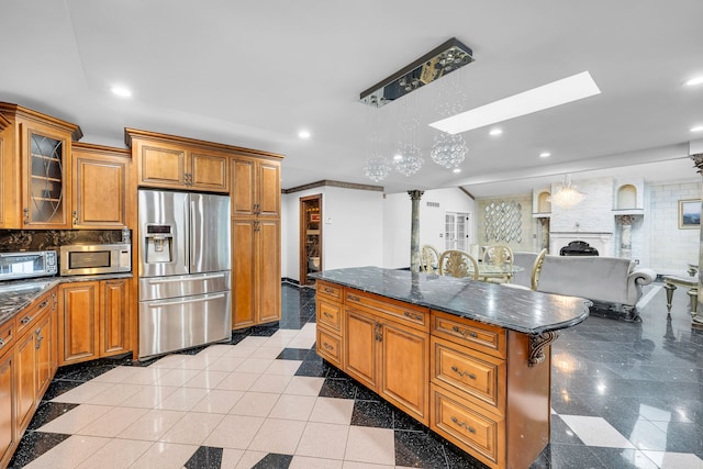 kitchen featuring granite finish floor, stainless steel appliances, and recessed lighting