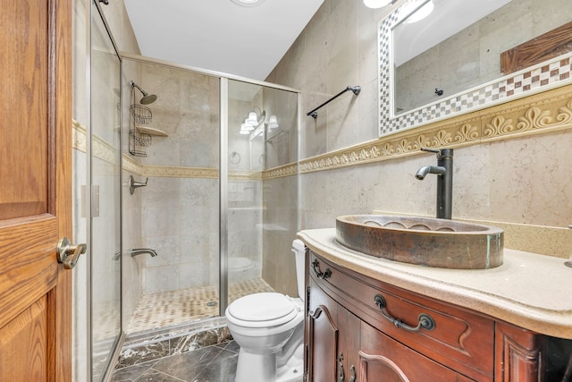 bathroom featuring toilet, vanity, a shower stall, and marble finish floor
