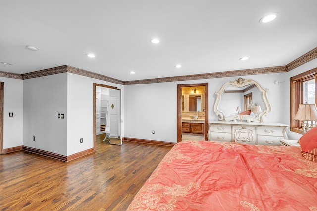 bedroom with dark wood finished floors, baseboards, crown molding, and recessed lighting