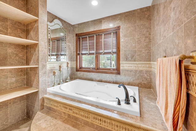 full bath featuring recessed lighting, a jetted tub, and tile walls