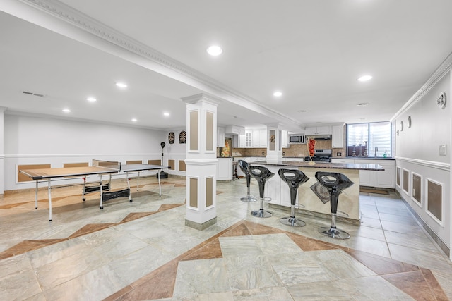 interior space featuring ornate columns, visible vents, recessed lighting, and ornamental molding