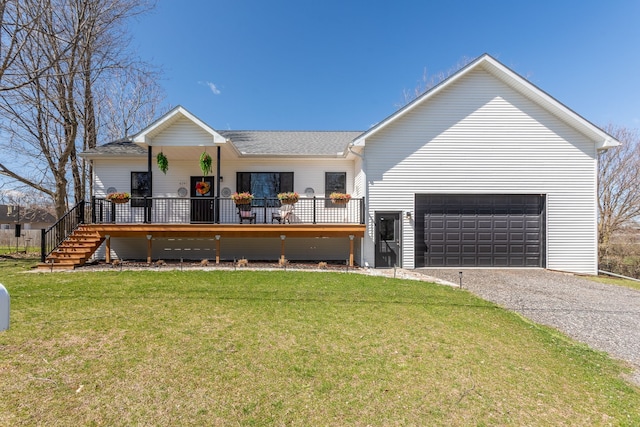 view of front facade with gravel driveway, a shingled roof, a front lawn, and a garage
