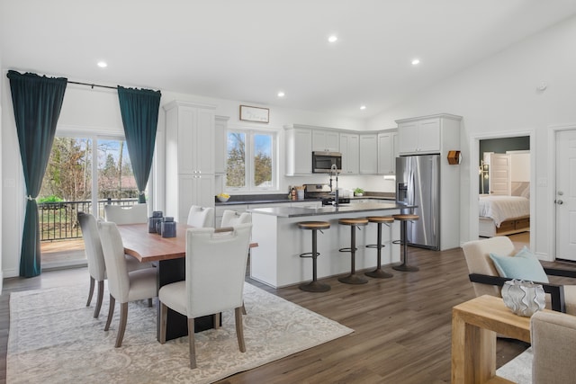 dining space featuring dark wood-style floors, recessed lighting, and a healthy amount of sunlight