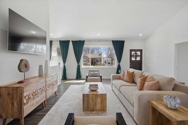 living area with recessed lighting, baseboards, and dark wood-type flooring
