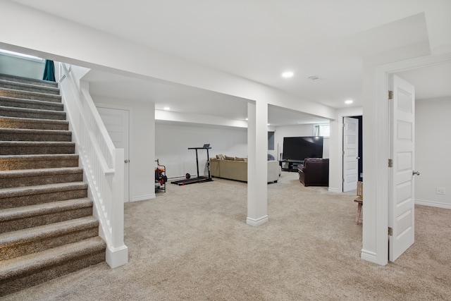 finished below grade area with baseboards, recessed lighting, light carpet, and stairs