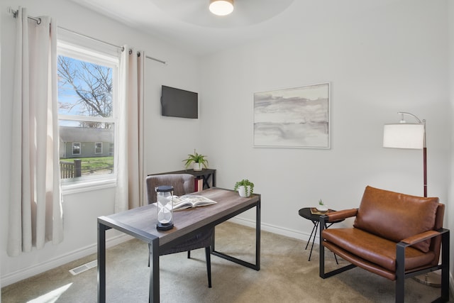 office featuring visible vents, ceiling fan, light carpet, and baseboards