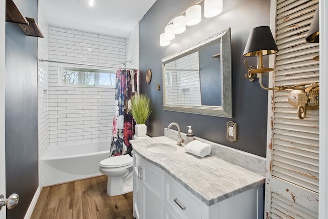 bathroom featuring toilet, vanity, shower / bath combination with curtain, and wood finished floors
