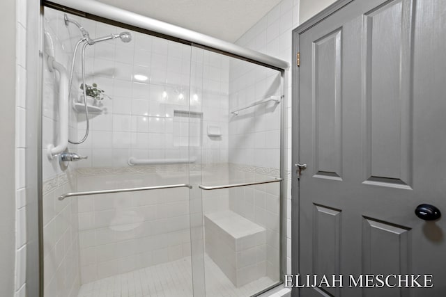 bathroom with a shower stall