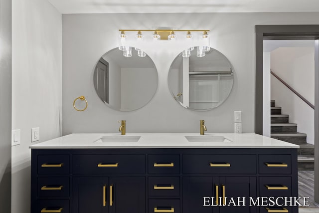 full bathroom with double vanity and a sink