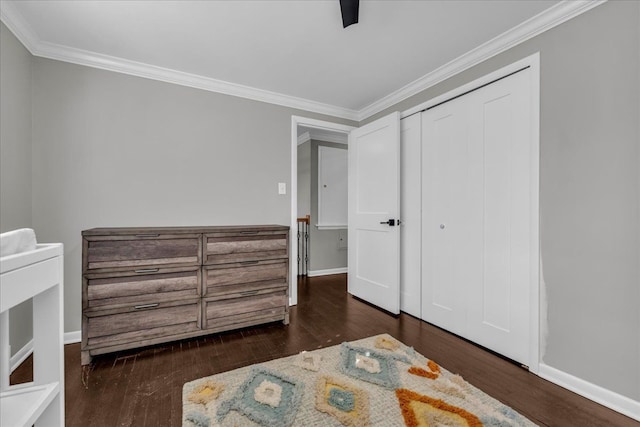 bedroom featuring crown molding, baseboards, and wood finished floors