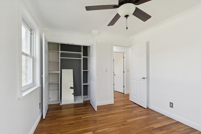 unfurnished bedroom featuring ornamental molding, wood finished floors, and baseboards