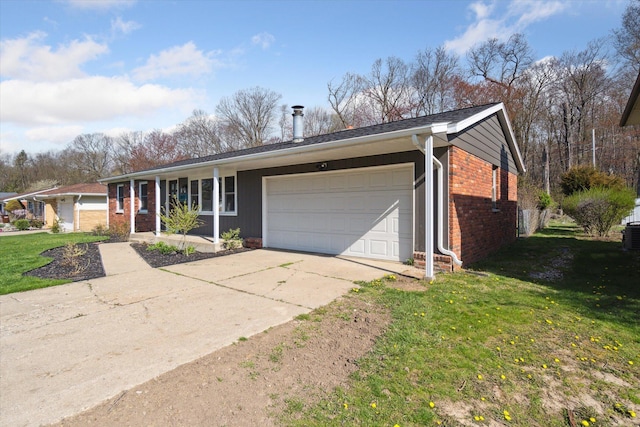 single story home with a porch, brick siding, a garage, driveway, and a front yard